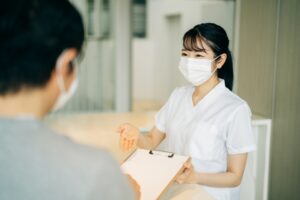 受付スタッフが患者さんを迎え入れている写真