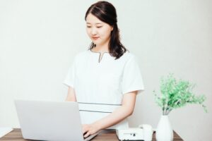 受付スタッフがスケジュール確認をパソコンでしている写真